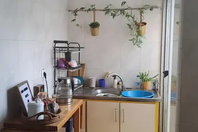 a kitchen with a sink and a counter top at Mendes Family Homestay - B&B In The Heart Of Praia in Praia