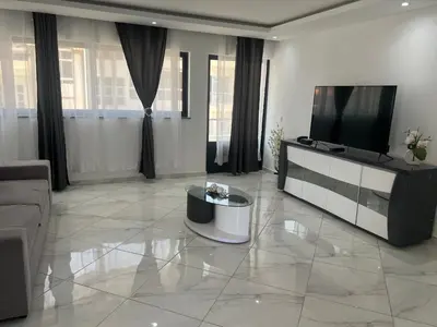 a living room with a flat screen tv and a couch at Residencial Santo Amaro in Tarrafal