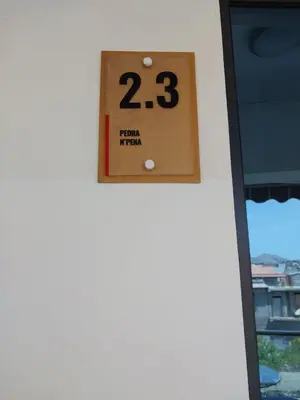 a clock on the side of a building at Residencial Santo Amaro in Tarrafal