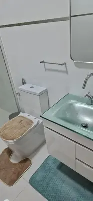 a bathroom with a toilet and a sink at SUITES-HOME, CIDADELA in Praia