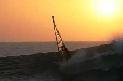 a person riding a wave on a surfboard in the ocean at Casa Bahia 5 in Santa Maria