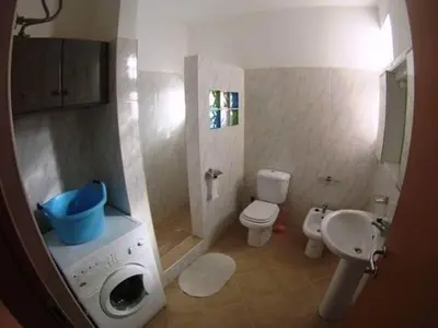 a small bathroom with a toilet and a sink at Casa Bahia 5 in Santa Maria
