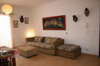 a living room with a couch and a chair at Casa Bahia 6 in Santa Maria