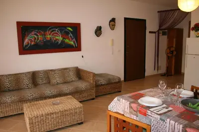 a living room with a couch and a table at Casa Bahia 6 in Santa Maria