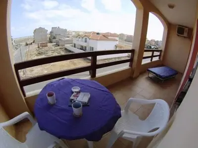 a table and chairs on a balcony with a view at Casa Bahia 7 in Santa Maria