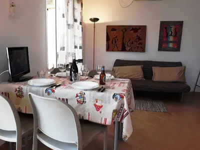 a dining room with a table with wine bottles on it at Casa Bahia 7 in Santa Maria