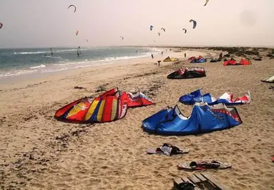 a group of people on a beach flying kites at Casa Bahia 7 in Santa Maria