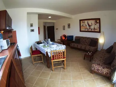 a living room with a table and a couch at Casa Bahia 8 in Santa Maria
