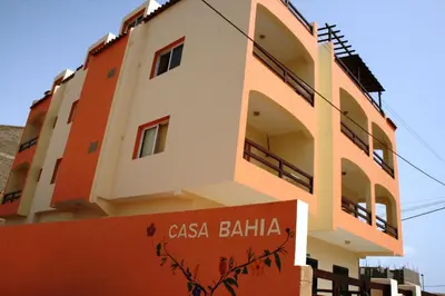 a building with a sign in front of it at Casa Bahia 8 in Santa Maria