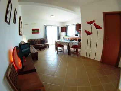 a living room with a table and a dining room at Casa Bahia 8 in Santa Maria