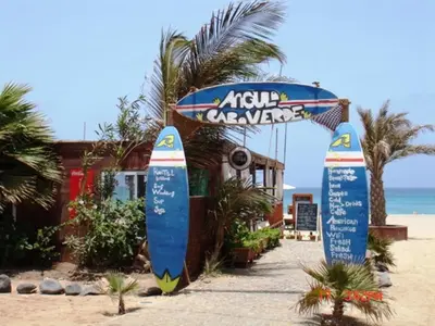 a couple of surfboards are standing on the beach at Casa Bahia 10 Grande Penthouse in Santa Maria