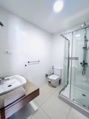 a bathroom with a sink and a shower and a toilet at Bliss Apartments T1 - Adélia in Mindelo