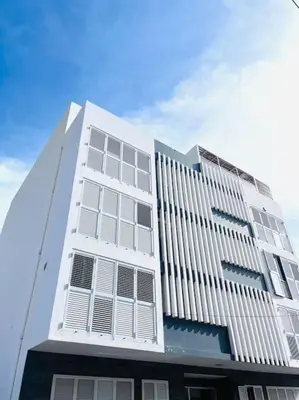 a white building with many windows on top of it at Bliss Apartments T1 - Adélia in Mindelo