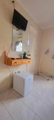 a room with a television and a white box on the floor at OpenSky in São Filipe