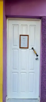 a white garage door with a picture on it at OpenSky in São Filipe