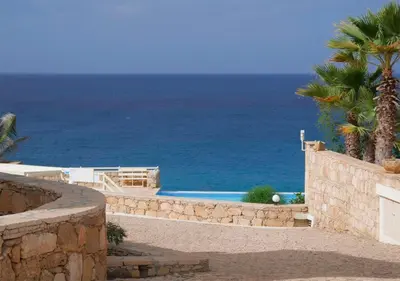 a swimming pool with the ocean in the background at Appartamento BICA. Stella Maris Exclusive in Calheta Do Maio