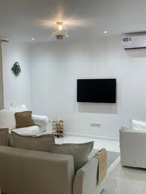 a living room with couches and a flat screen tv at Ocean View Santa Filomena in Mindelo