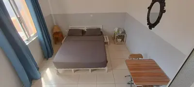 a small bedroom with a bed and a table at Óscar in Mindelo