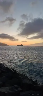a ship in the middle of the ocean at sunset at Óscar in Mindelo
