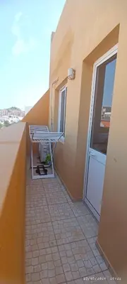 a balcony with a door on the side of a building at Óscar in Mindelo