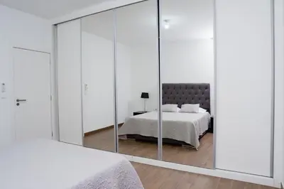 a bedroom with mirrored walls and a bed at Villa Santiago in Praia
