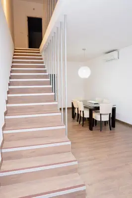a staircase leading up to a dining room with a table at Villa Santiago in Praia
