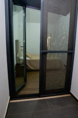 a sliding glass door leading to a bedroom at Villa Santiago in Praia