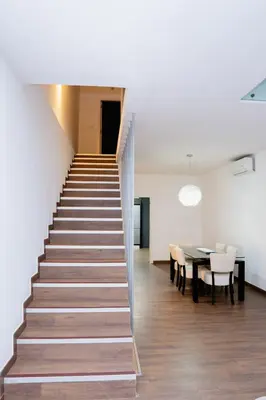 a staircase leading up to a dining room with a table at Villa Santiago in Praia