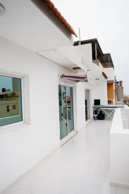 a white house with white floors and windows at Nhu Sao Francisco - PALMAREJO T3 in Praia