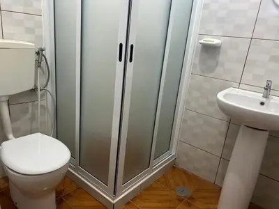 a bathroom with a shower and a toilet and a sink at Casa Manuel & Elvira in Chão Queimado