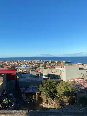 a group of buildings with the ocean in the background at Casa Graciosa in Tarrafal