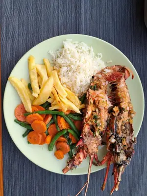 a plate of food with rice and vegetables and meat at Casa Graciosa in Tarrafal