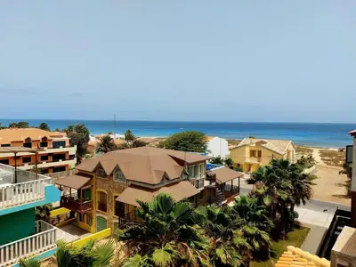 an aerial view of a beach with houses and the ocean at Branco Sea Holiday Apartments in Santa Maria