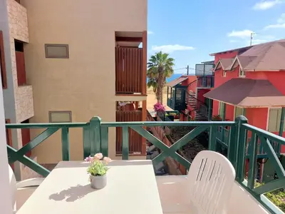 a balcony with a table and chairs on a balcony at Branco Sea Holiday Apartments in Santa Maria