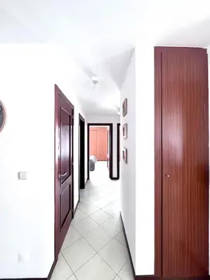 a hallway with an open door and a hallway with white walls at Bliss Apartments T3 - Zita - On The Beach in Mindelo