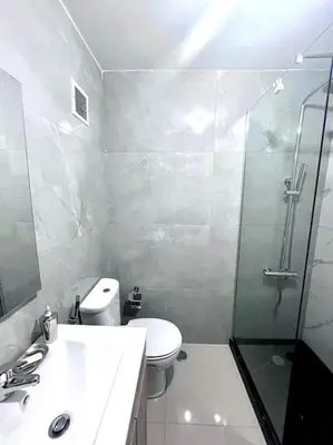 a bathroom with a shower and a toilet and a sink at Bliss Apartments T3 - Zita - On The Beach in Mindelo