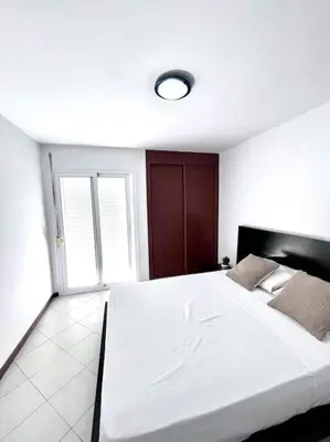 a bedroom with a large white bed in a room at Bliss Apartments T3 - Zita - On The Beach in Mindelo
