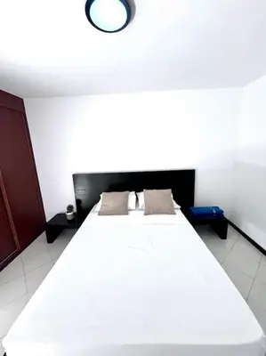 a bedroom with a large white bed with two pillows at Bliss Apartments T3 - Zita - On The Beach in Mindelo
