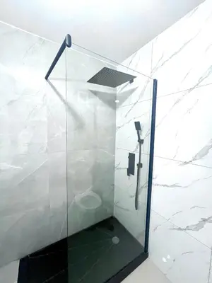 a shower with a glass door in a bathroom at Bliss Apartments T3 - Zita - On The Beach in Mindelo