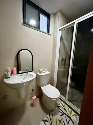 a bathroom with a toilet and a sink and a shower at Modern Apartment in Praia Baixo - 1 min Walking to Beach in Praia Baixo