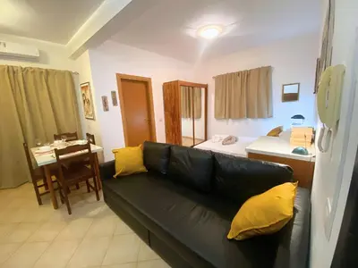 a living room with a couch and a bedroom at Studio Apt Bounty Condominium, Santa Maria in Santa Maria
