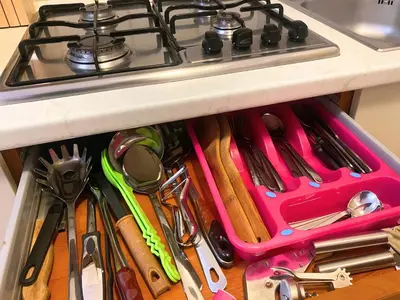 a drawer full of cooking utensils under a stove at Studio Apt Bounty Condominium, Santa Maria in Santa Maria