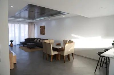 a living room with a table and a couch at Maison da Praia in Praia