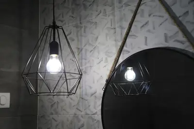 two lights and a mirror in a room at Maison da Praia in Praia