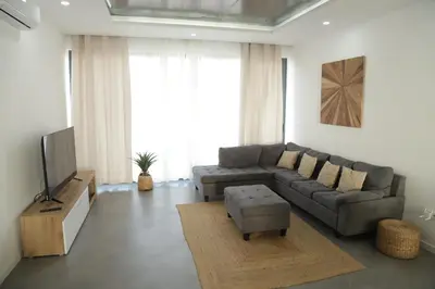 a living room with a couch and a tv at Maison da Praia in Praia