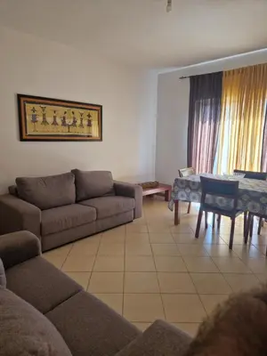 a living room with a couch and a table at Condomínio palma azul II in Praia