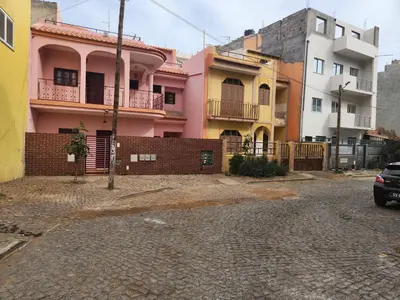 a parking lot in front of some buildings at Casa Cor de Rosa in Praia