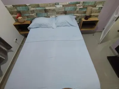 a large white bed in a small room at Residencia BB in Praia