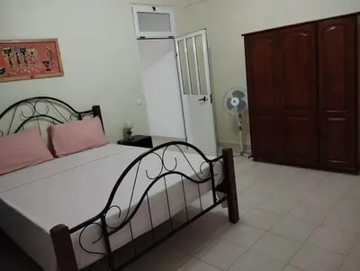 a bedroom with a bed and a closet and a door at Residencia BB in Praia