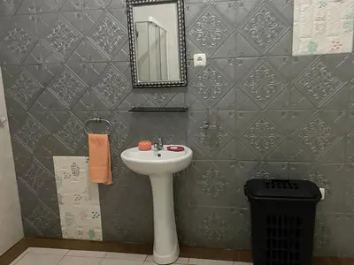 a bathroom with a sink and a mirror at Residencia BB in Praia